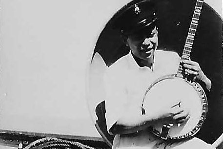 A man playing a banjo in a black and white photo