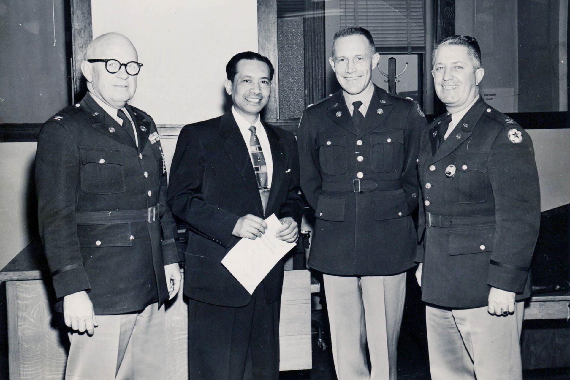 A black and white photo of four men in military uniforms