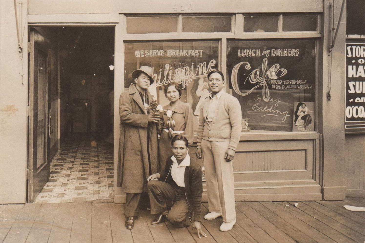 A group of people standing in front of a Filipino cafe