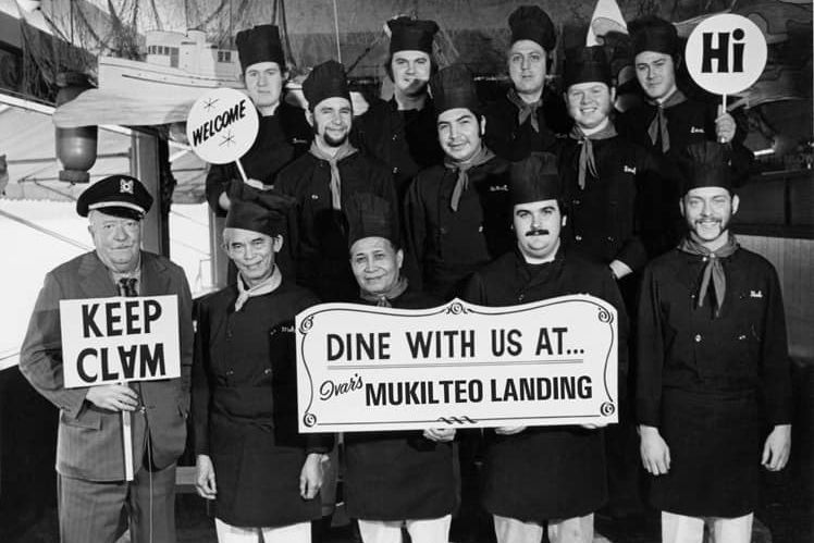 A group of men holding signs that say things like