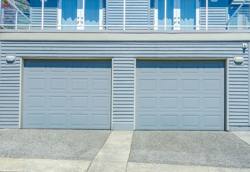 Two Light Blue Garage Doors — Peterson Property Valuations Brisbane in Northern Growth Corridor, QLD
