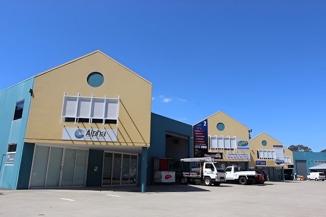 Blue and Yellow Commercial Buildings — Peterson Property Valuations Brisbane in Caloundra West, QLD