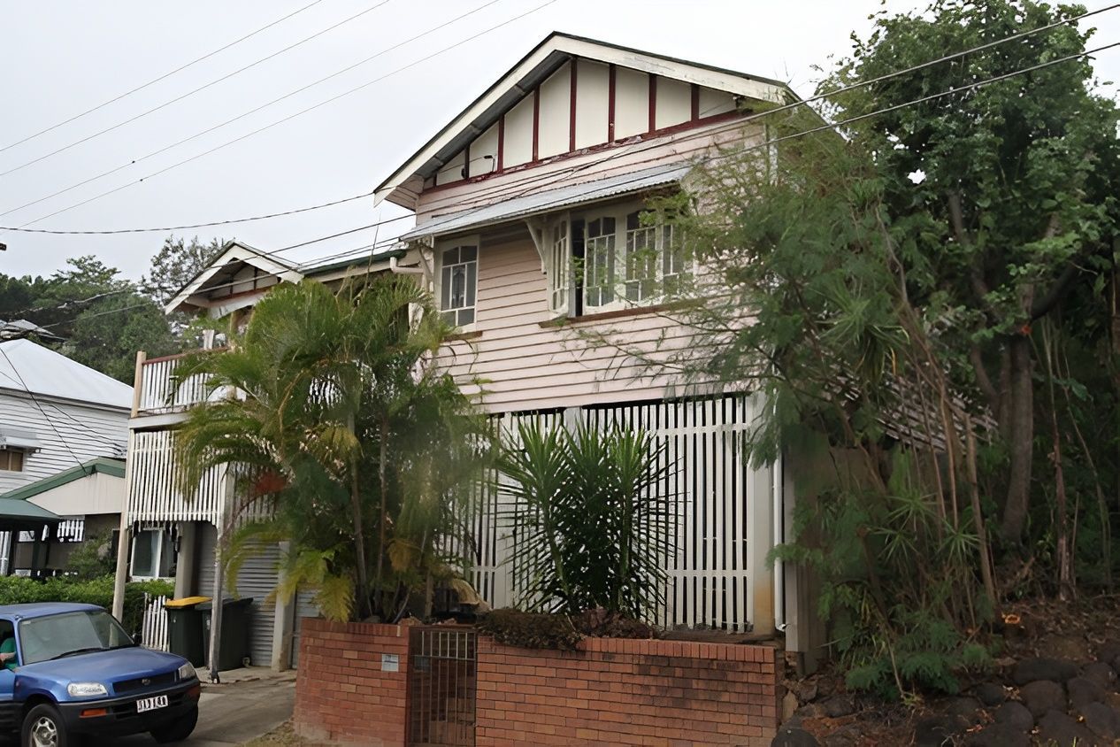 Two-Story House With Light Pink Siding — Peterson Property Valuations Brisbane in Ipswich, QLD