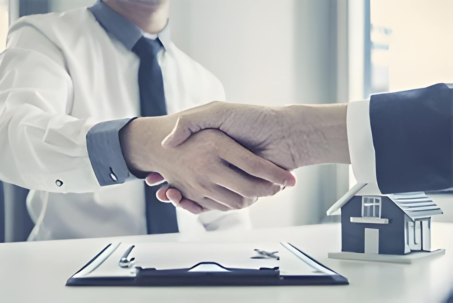 Two People Shaking Hands Over a Real Estate Contract — Peterson Property Valuations Brisbane in Caloundra West, QLD