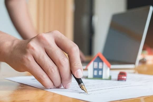 Person's Hand Signing Document — Peterson Property Valuations Brisbane in Brisbane West, QLD