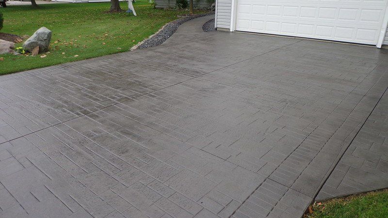 Gray stamped concrete driveway with textures