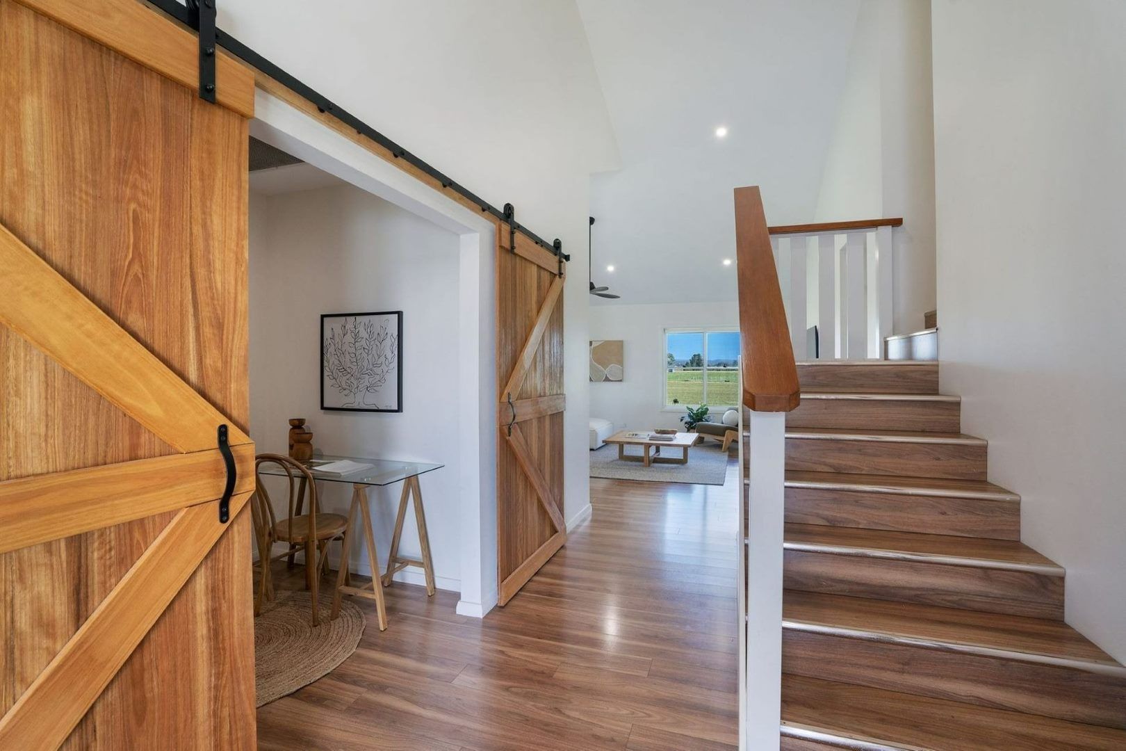 A Hallway With Wooden Floors and Stairs Leading Up to the Second Floor — Jonobilt in Bolwarra, NSW
