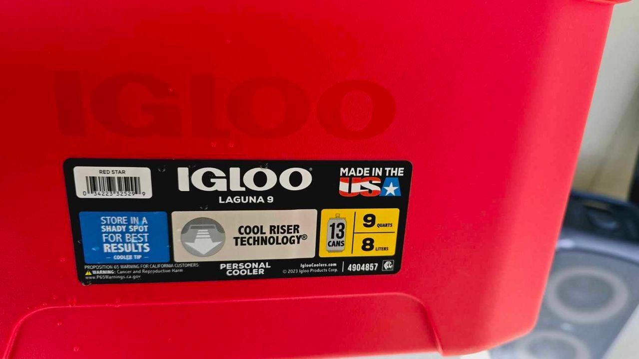 A red igloo cooler is sitting on a table.