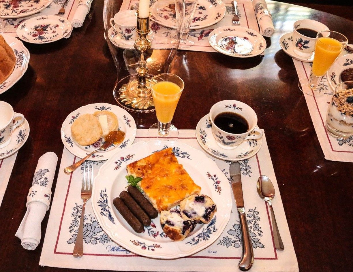 A table with plates of food and drinks on it