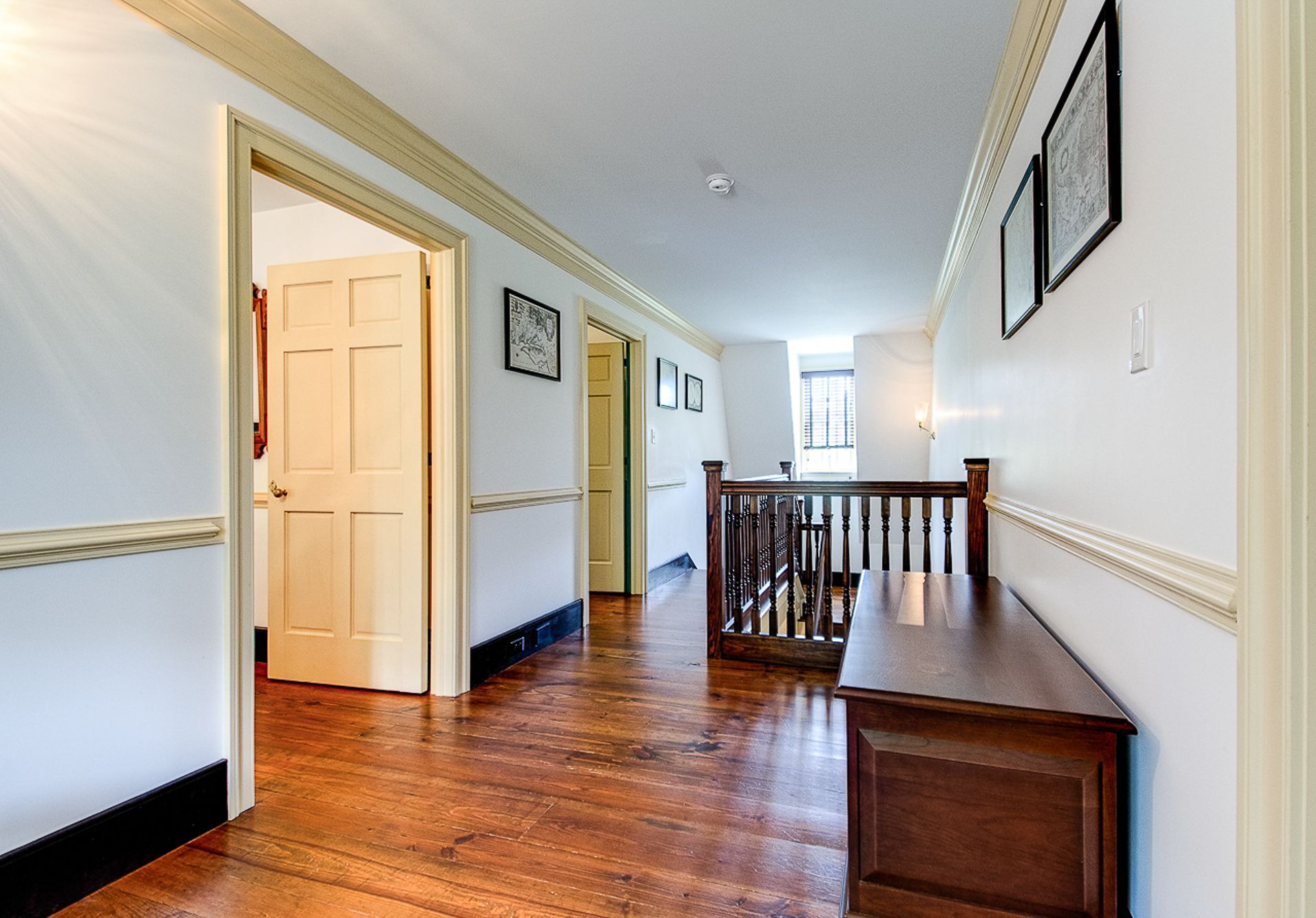 This is a photo of the upper bedrooms sitting area which focuses on the Green Room's door. It also shows the Peach Room door and stairwell.