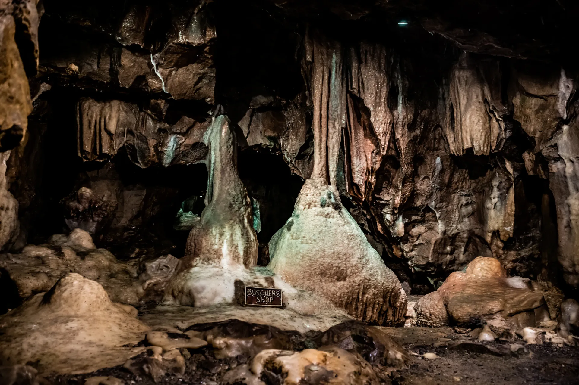 A cave filled with lots of rocks and ice formations.