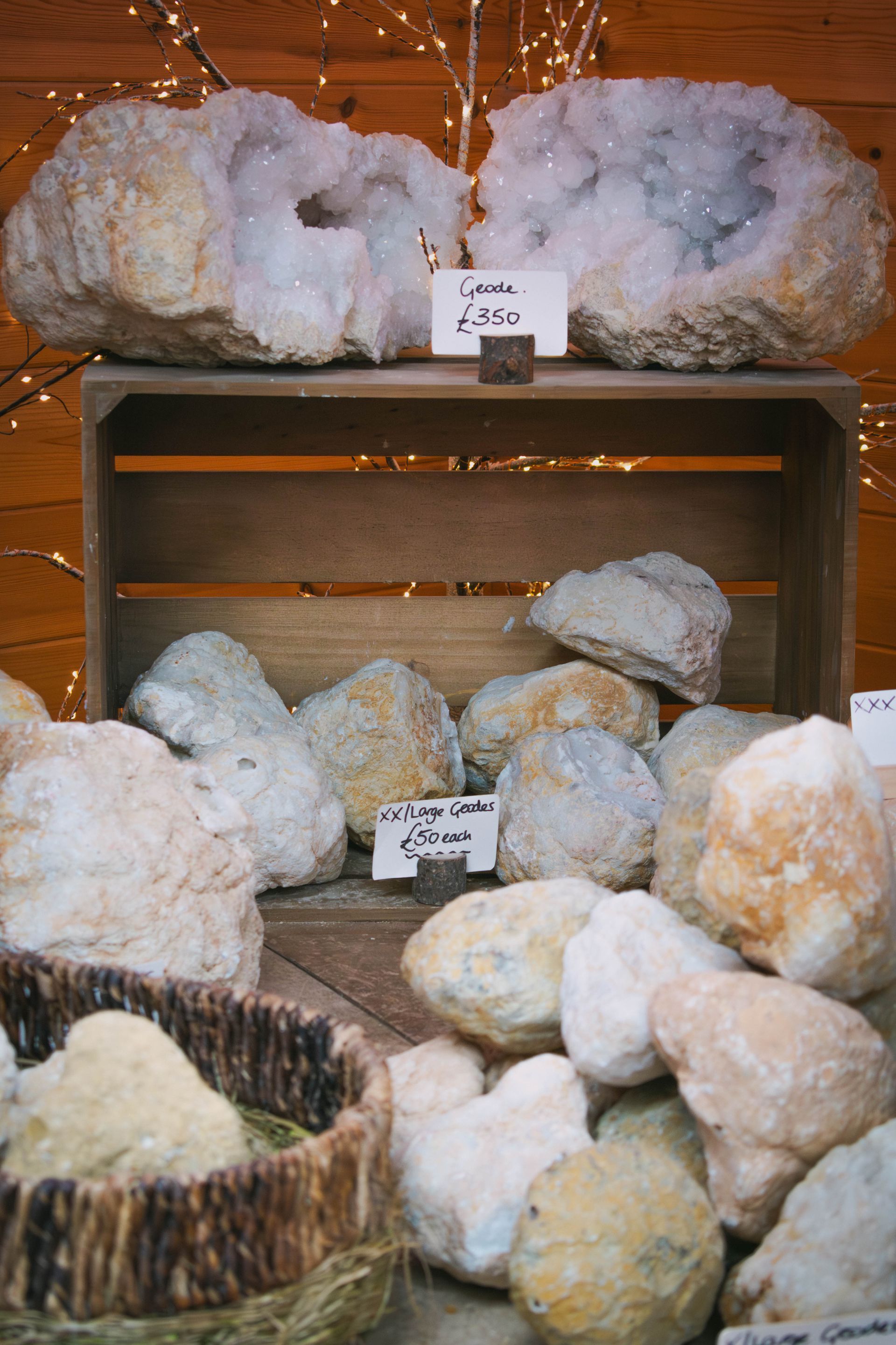 Close-up of a pile of various light-colored, irregularly-shaped rocks; some have a crystallized surface.