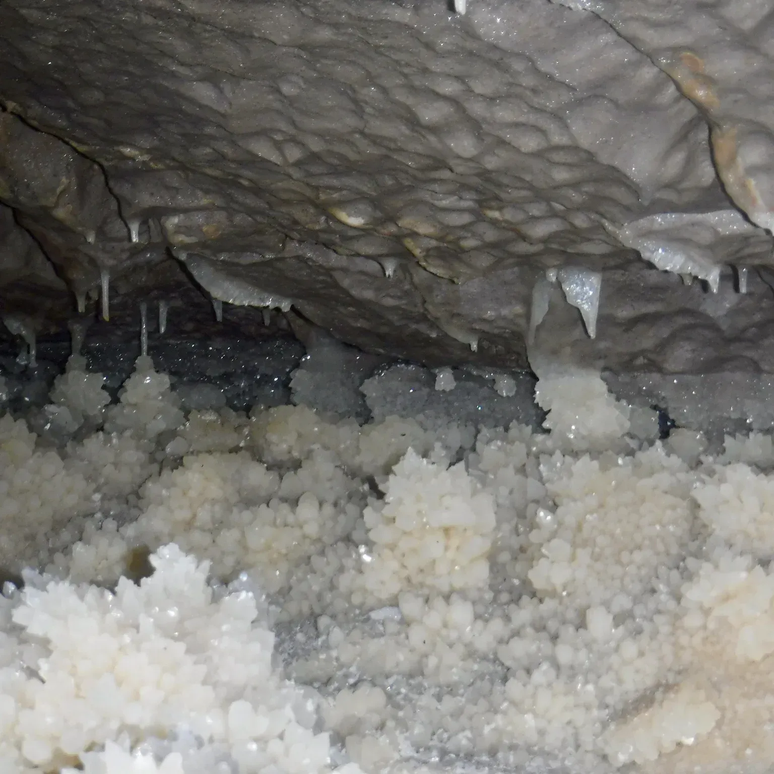 A cave filled with a lot of white crystals