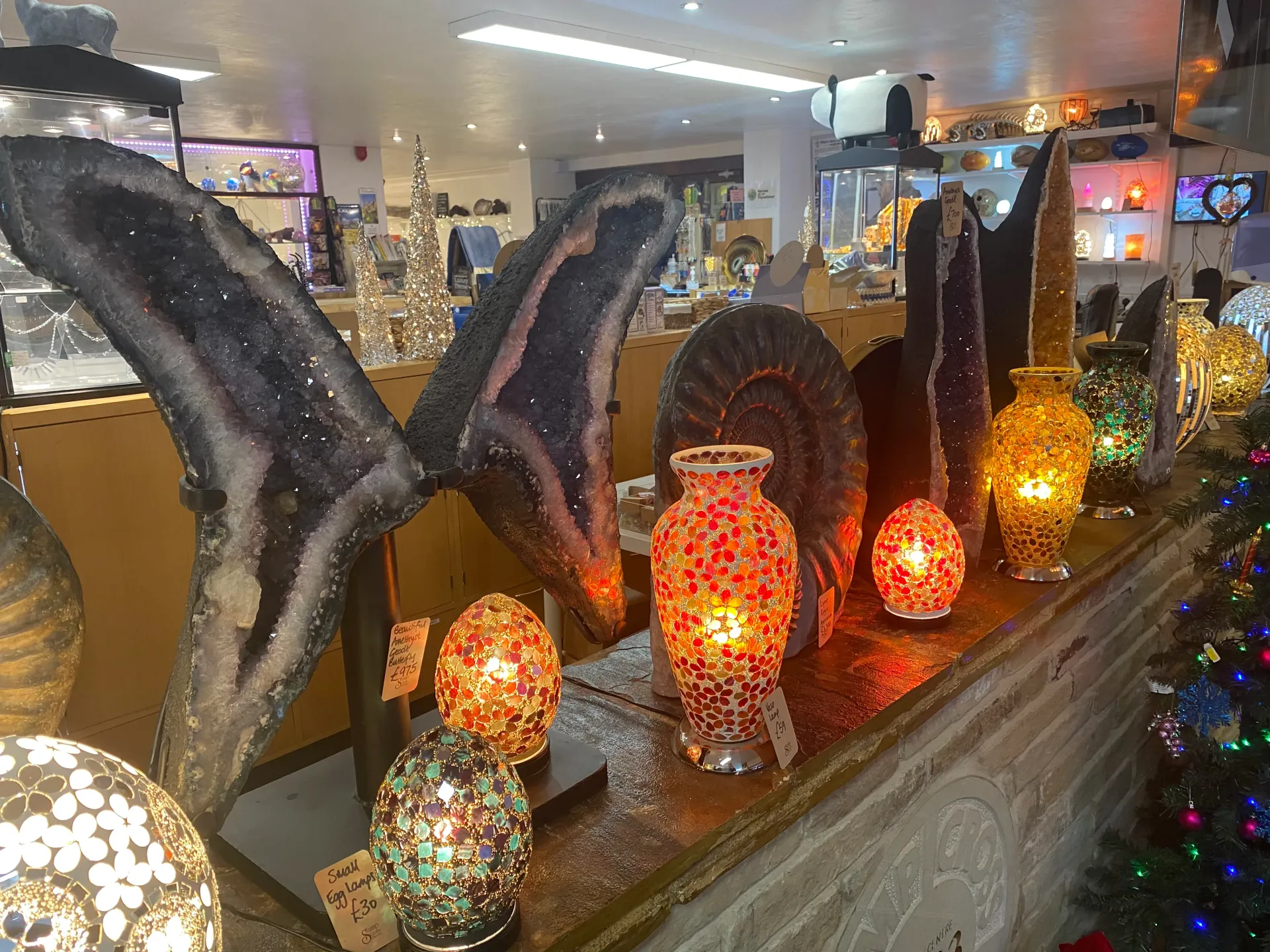 A row of lamps are sitting on a table in a store.