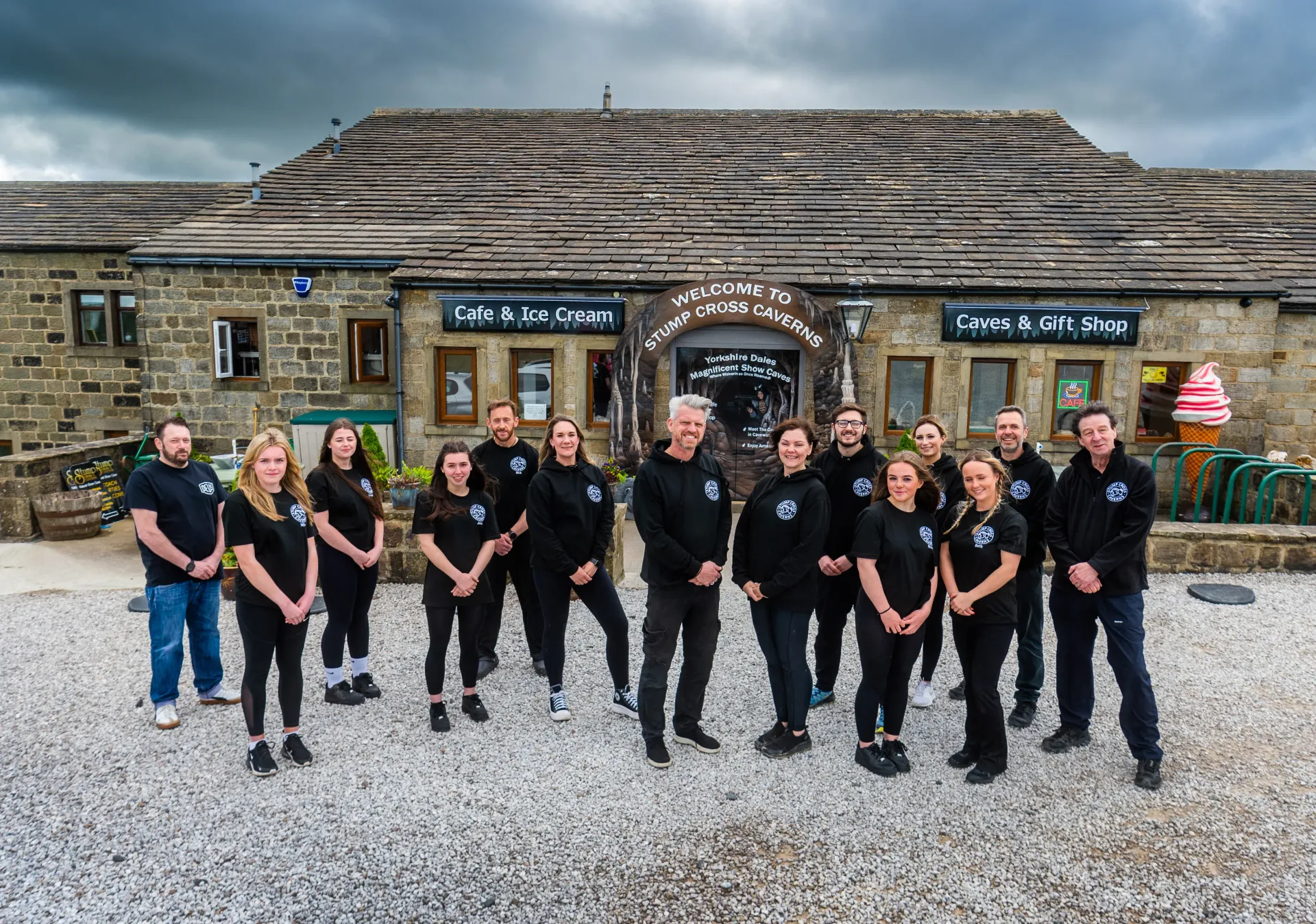 A group of people are posing for a picture in front of a building.