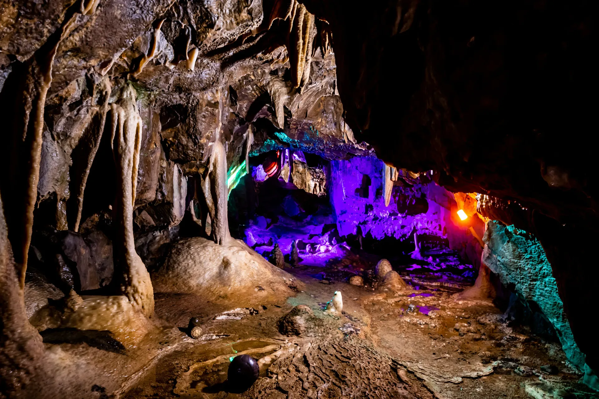 A cave filled with lots of rocks and glowing lights.