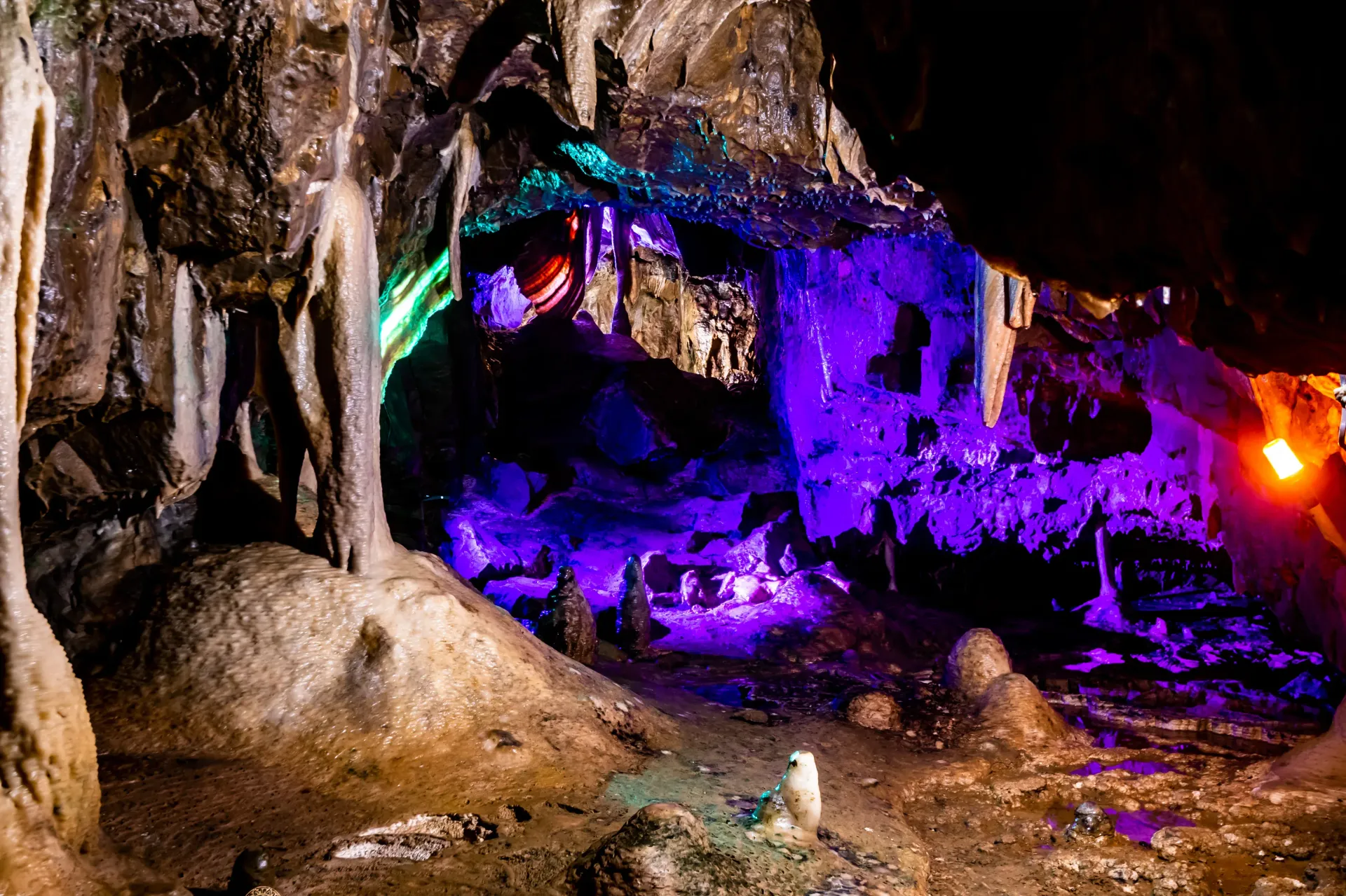 A cave filled with lots of rocks and purple lights.