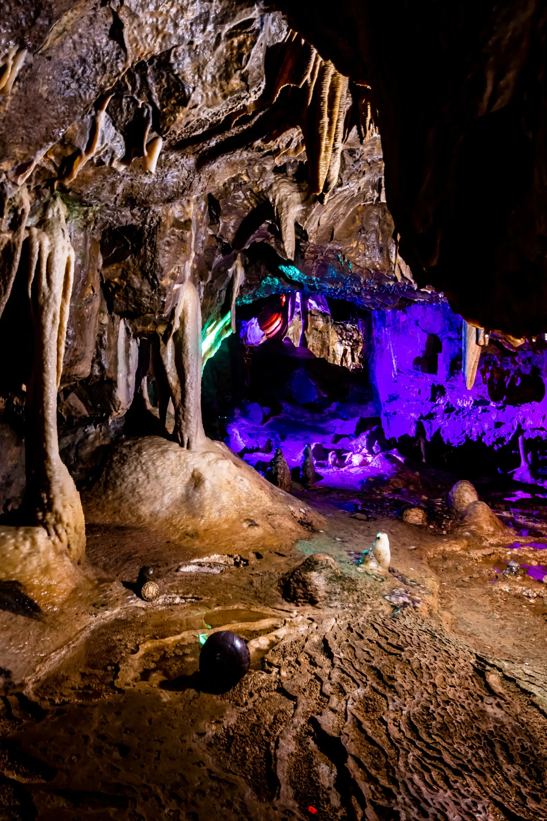 A cave filled with lots of rocks and purple lights.
