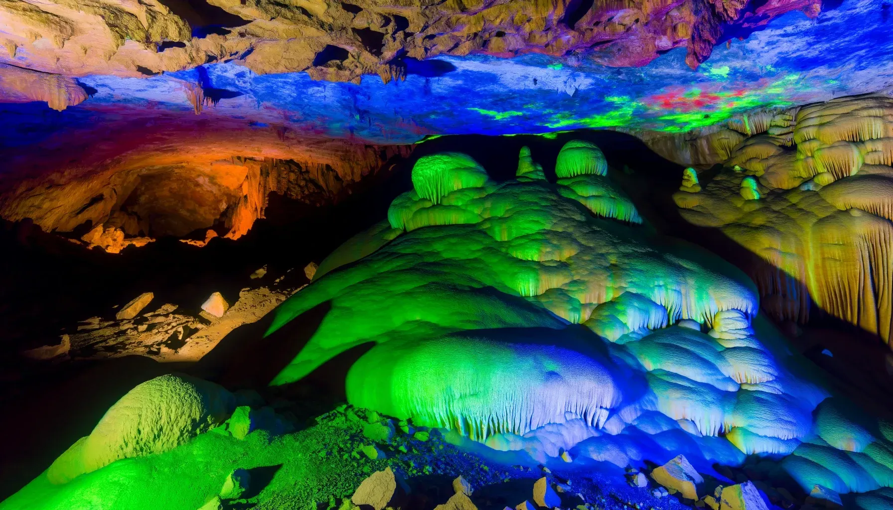 A cave with colorful lights on the ceiling and walls.
