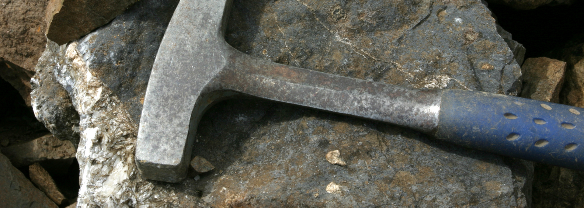 Picture of a rock and a hammer.