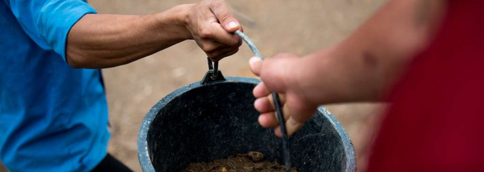 Picture of a bucket full of mud.