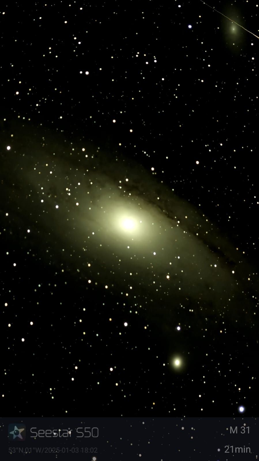 Milky Way galaxy with a bright yellow core and scattered stars in a dark sky.