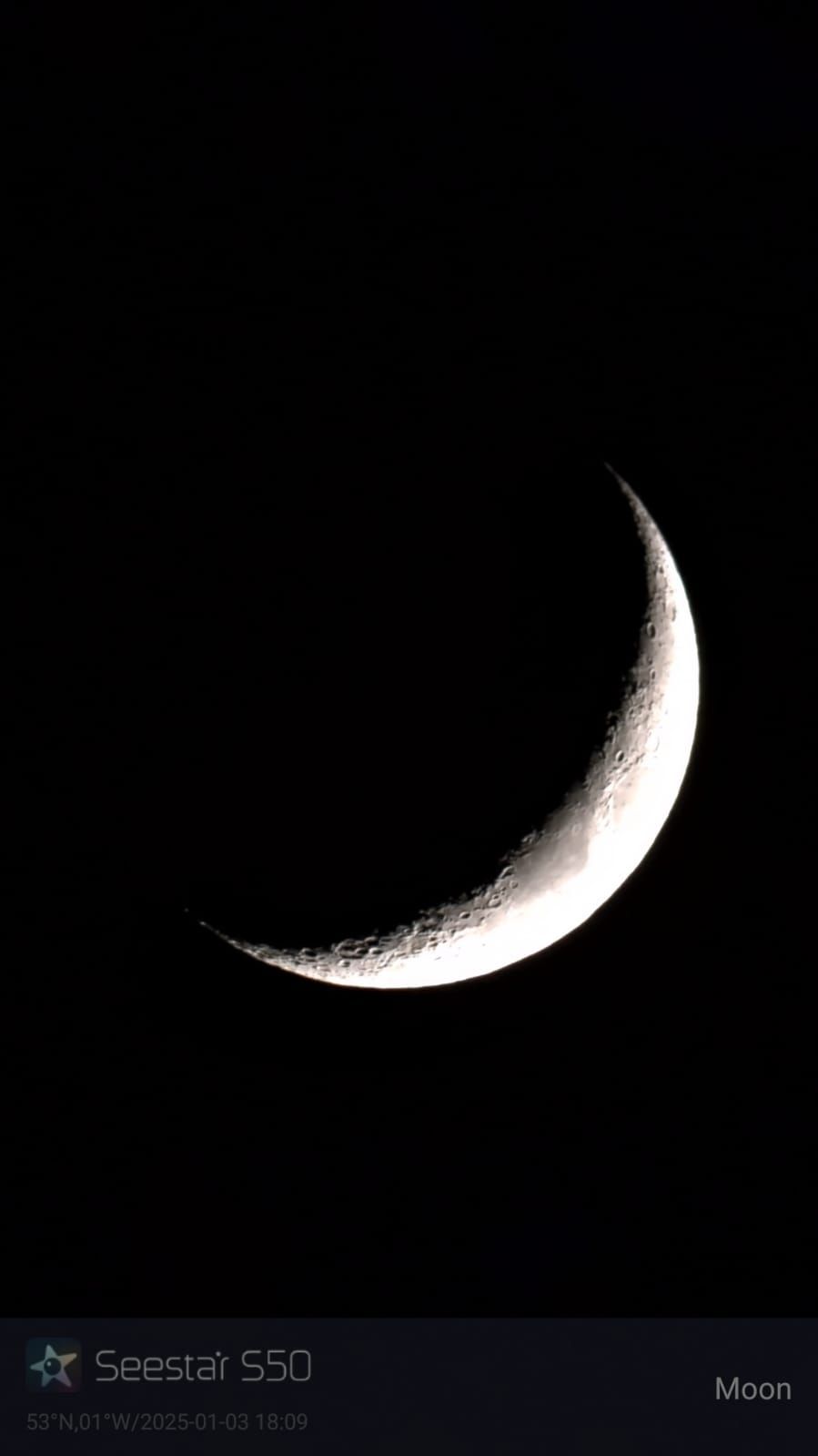 Crescent moon against a black sky.