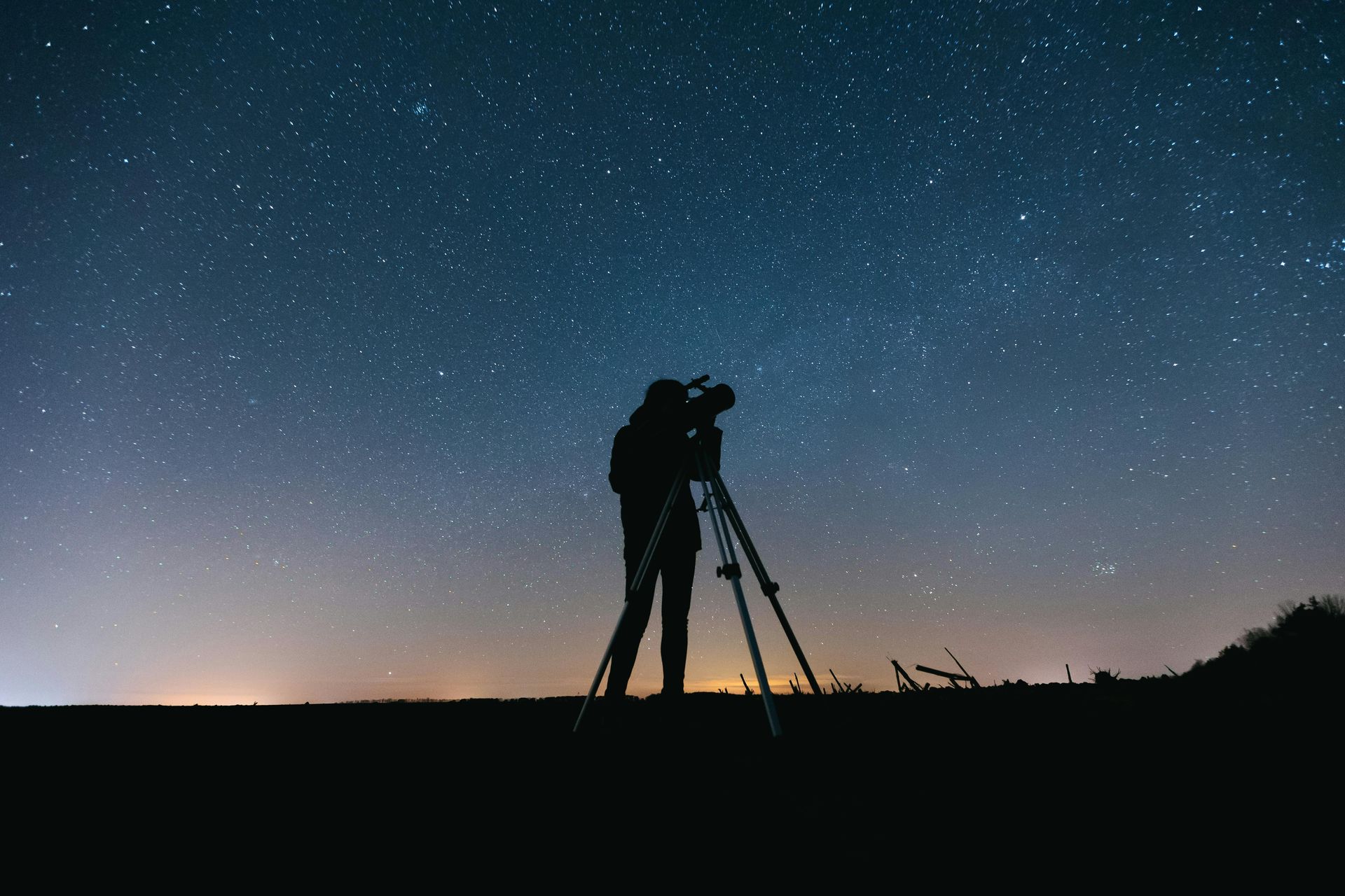 Picture of a telescope against a dark, twinkly sky