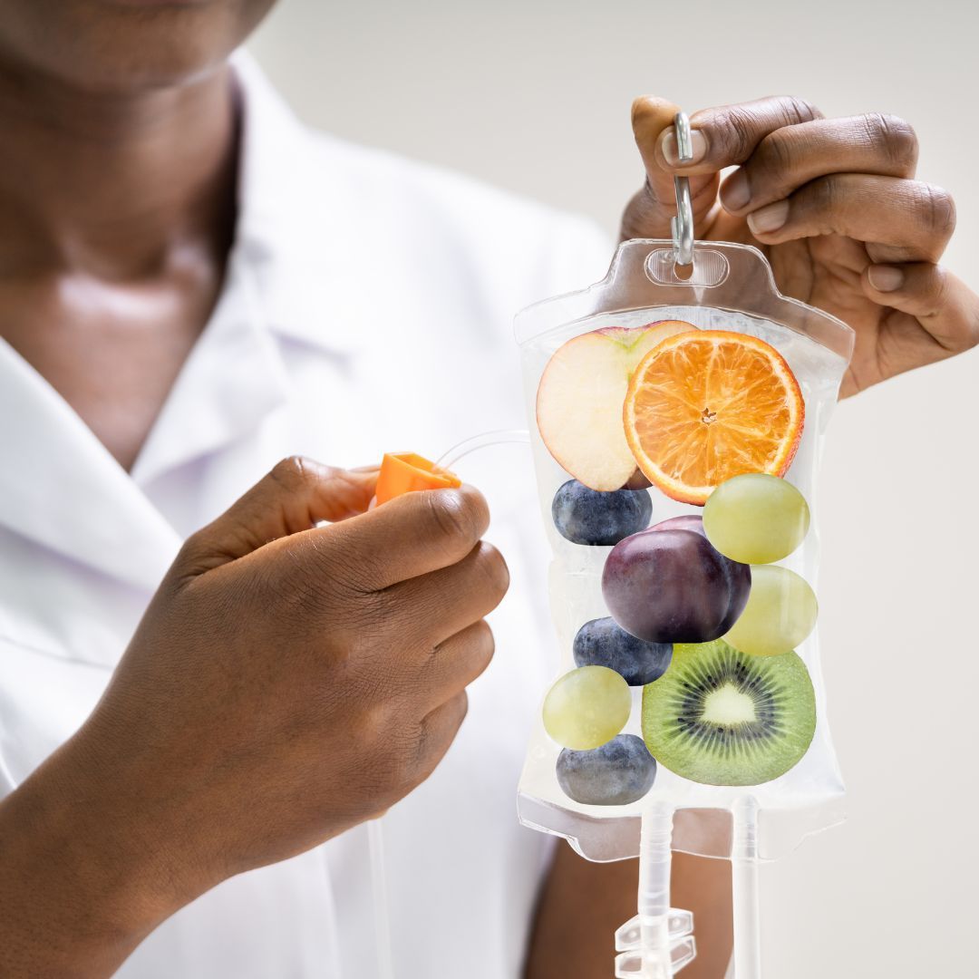 A woman is holding a bag of fruit in her hand