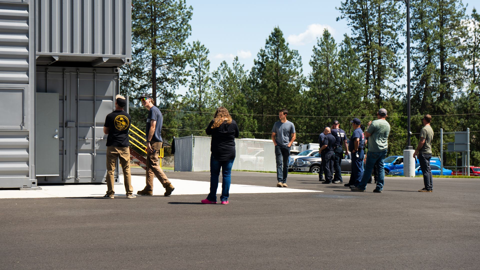 people talking outside of a firefighter training facility