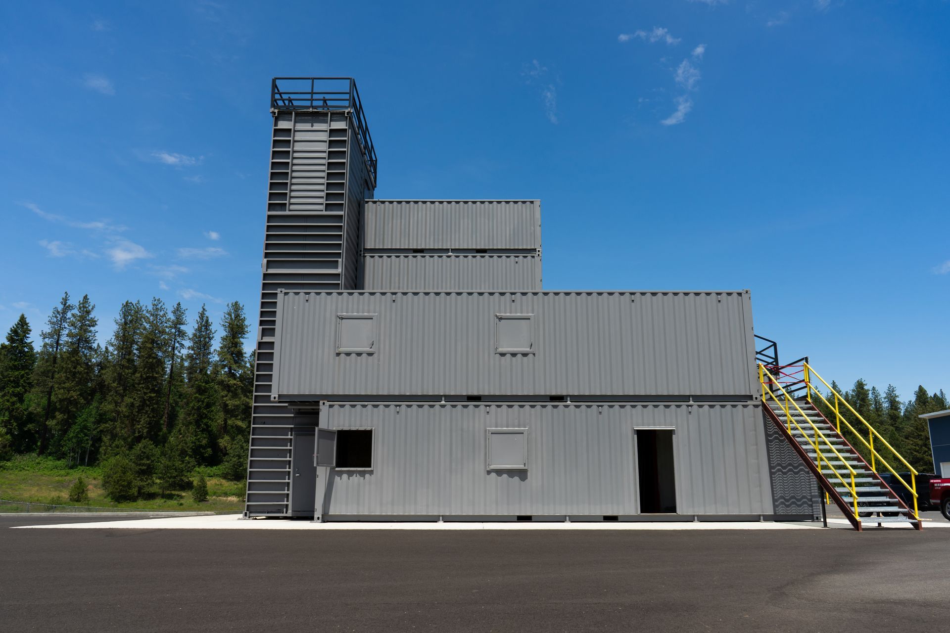 A tall firefighter training facility made out of shipping containers