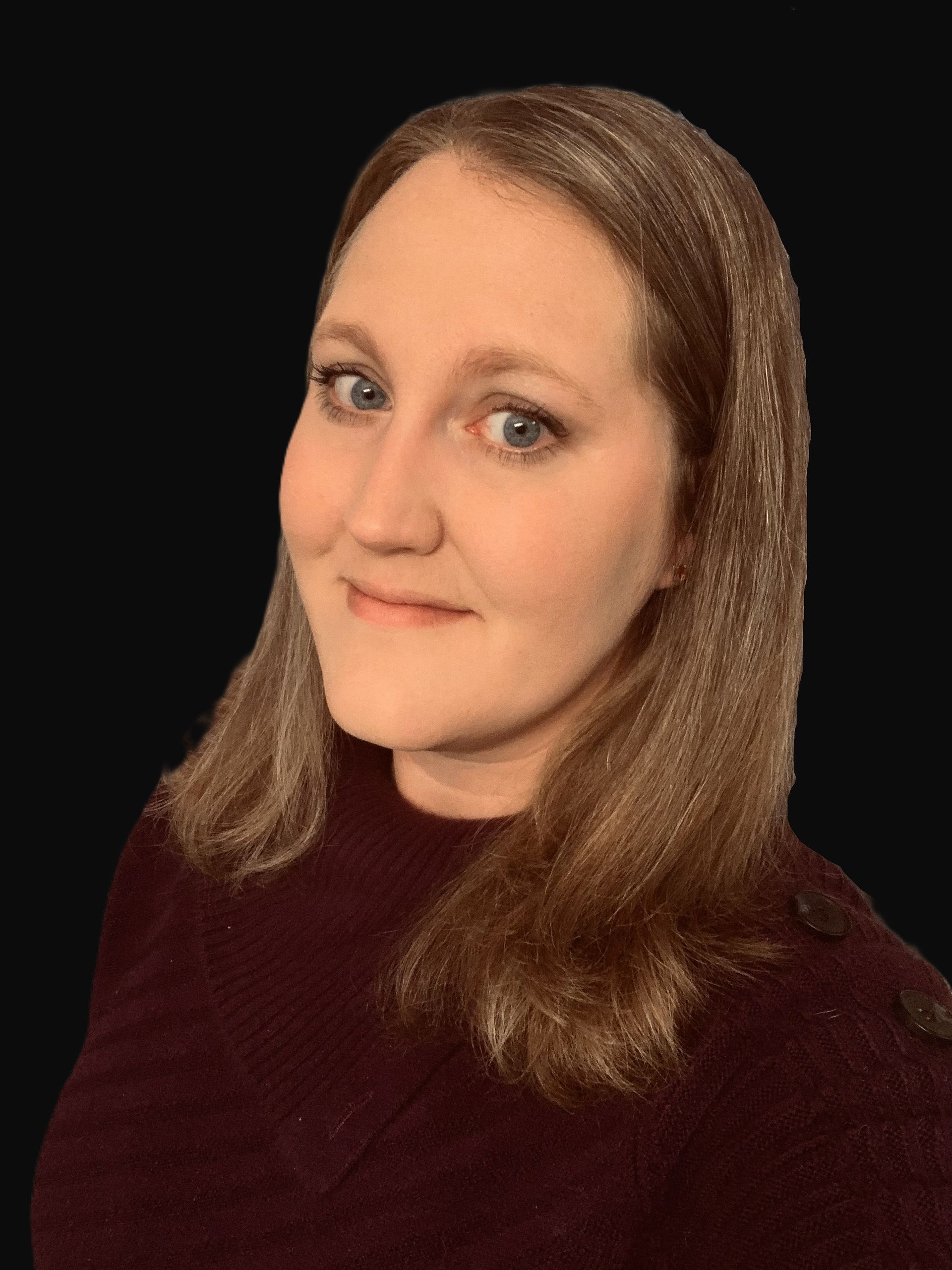 A woman with long brown hair is wearing a maroon sweater and smiling.