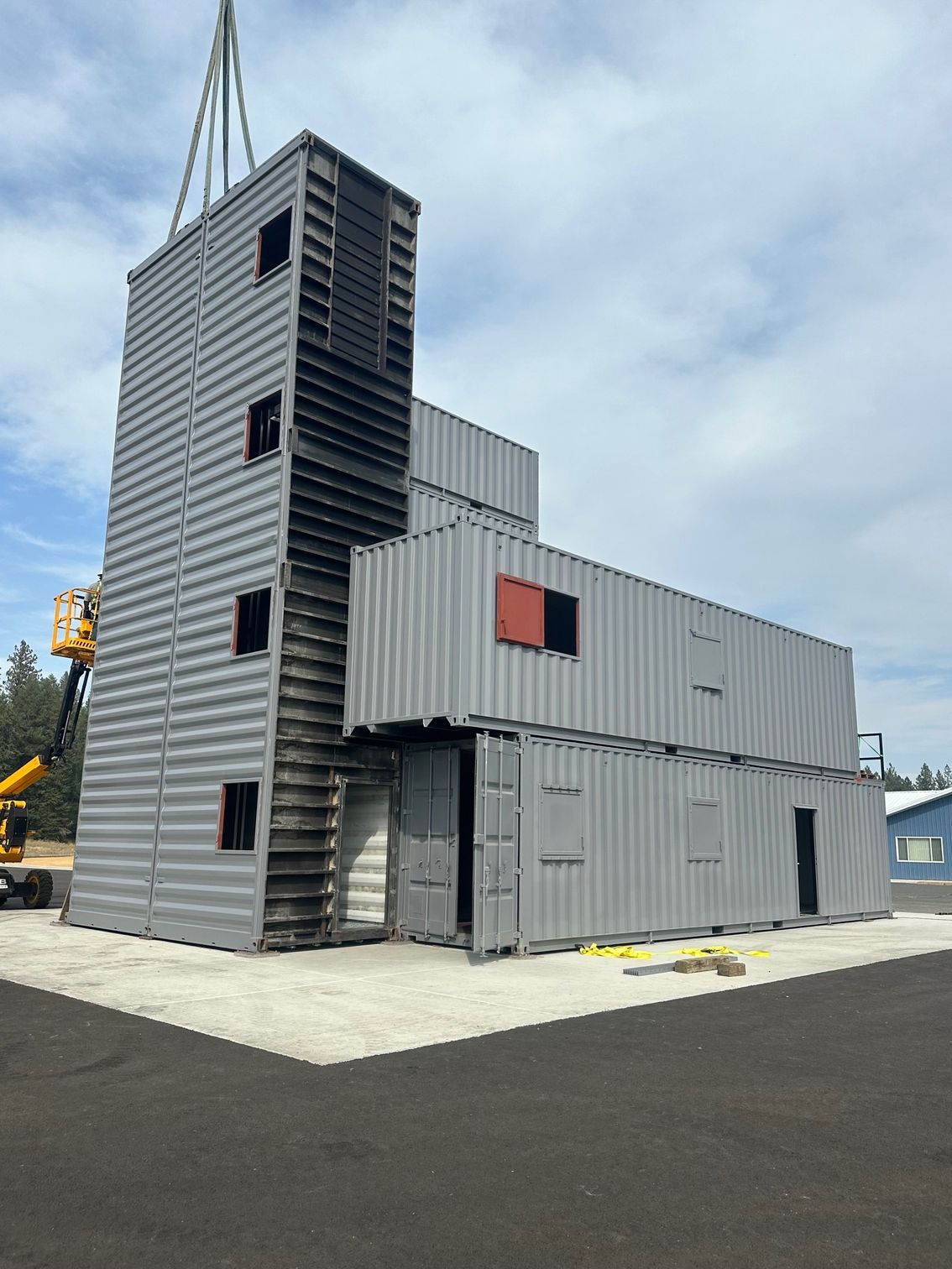 A large building is being built out of shipping containers
