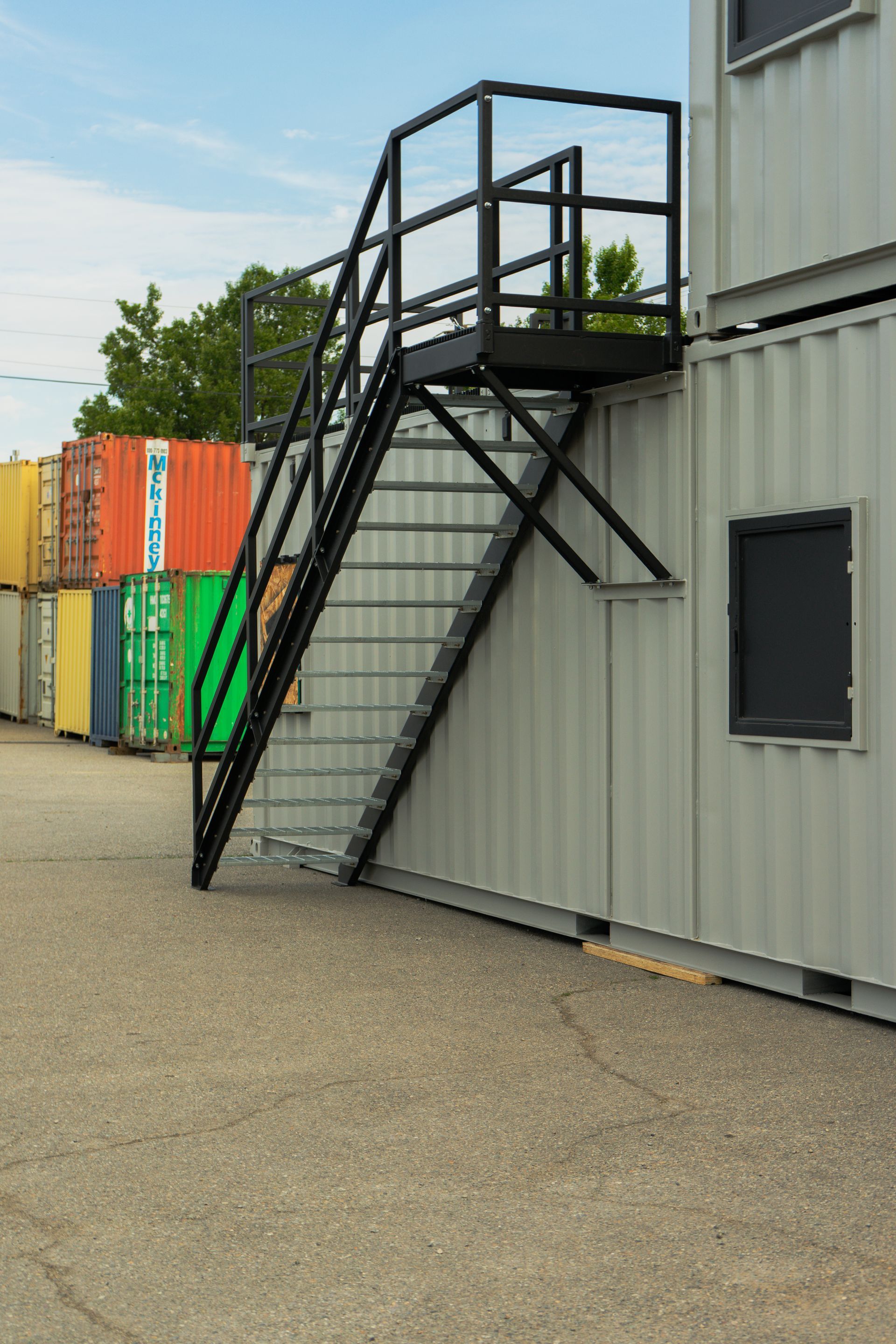 a shipping container with stairs connected to it