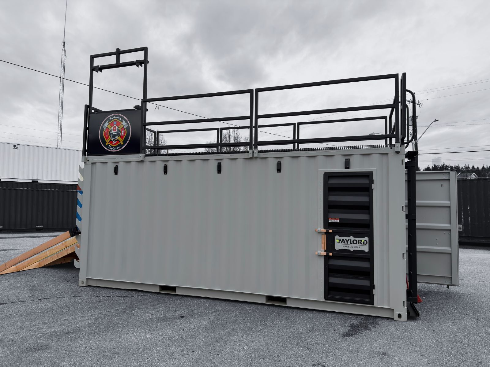 White container with a door and hinged overhead awning.