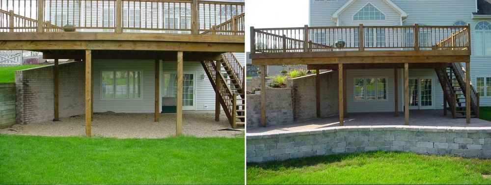 Two-story home with a deck and a lower-level patio, constructed with wood and concrete, green grass.