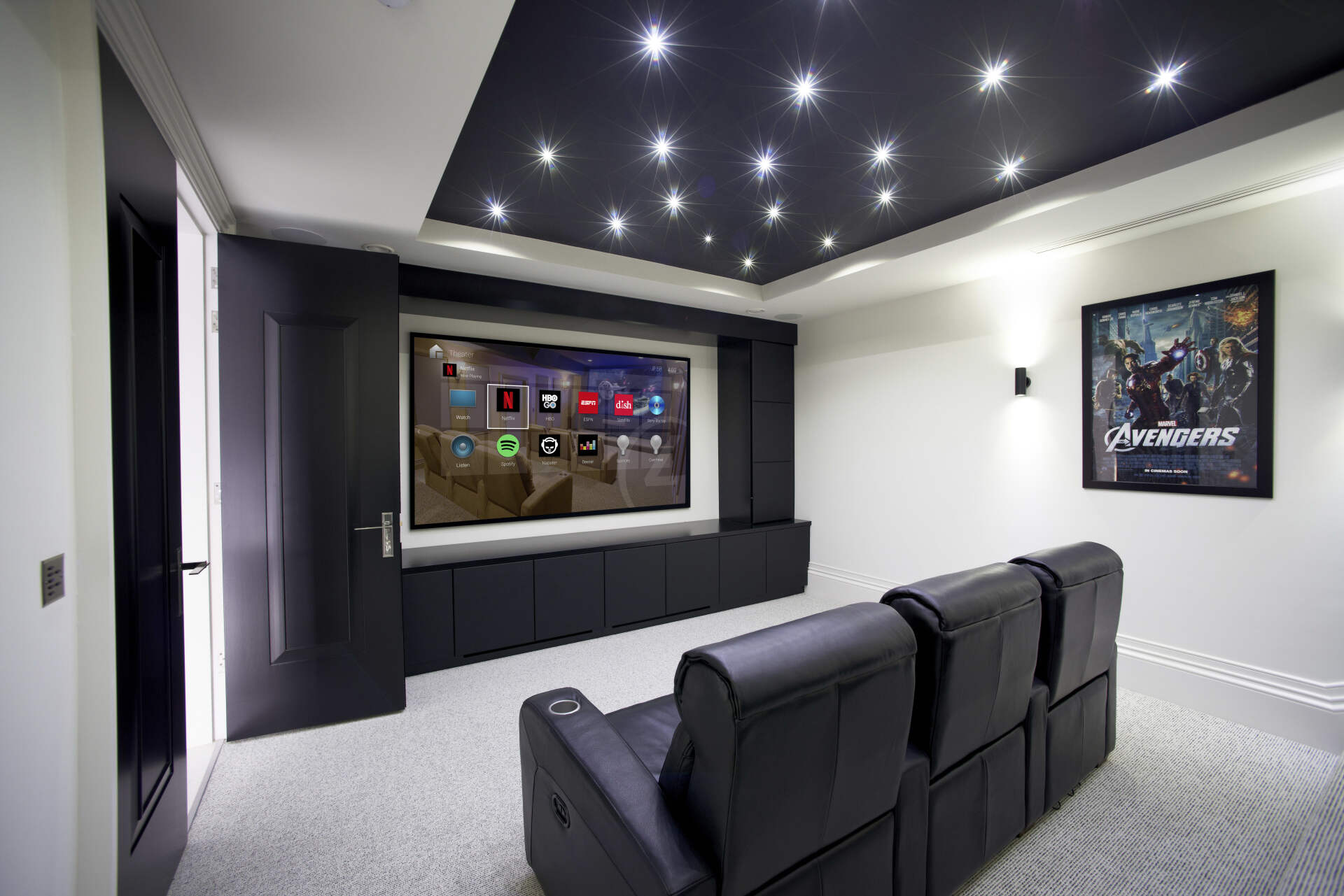 A home theater with a couch and a flat screen tv.