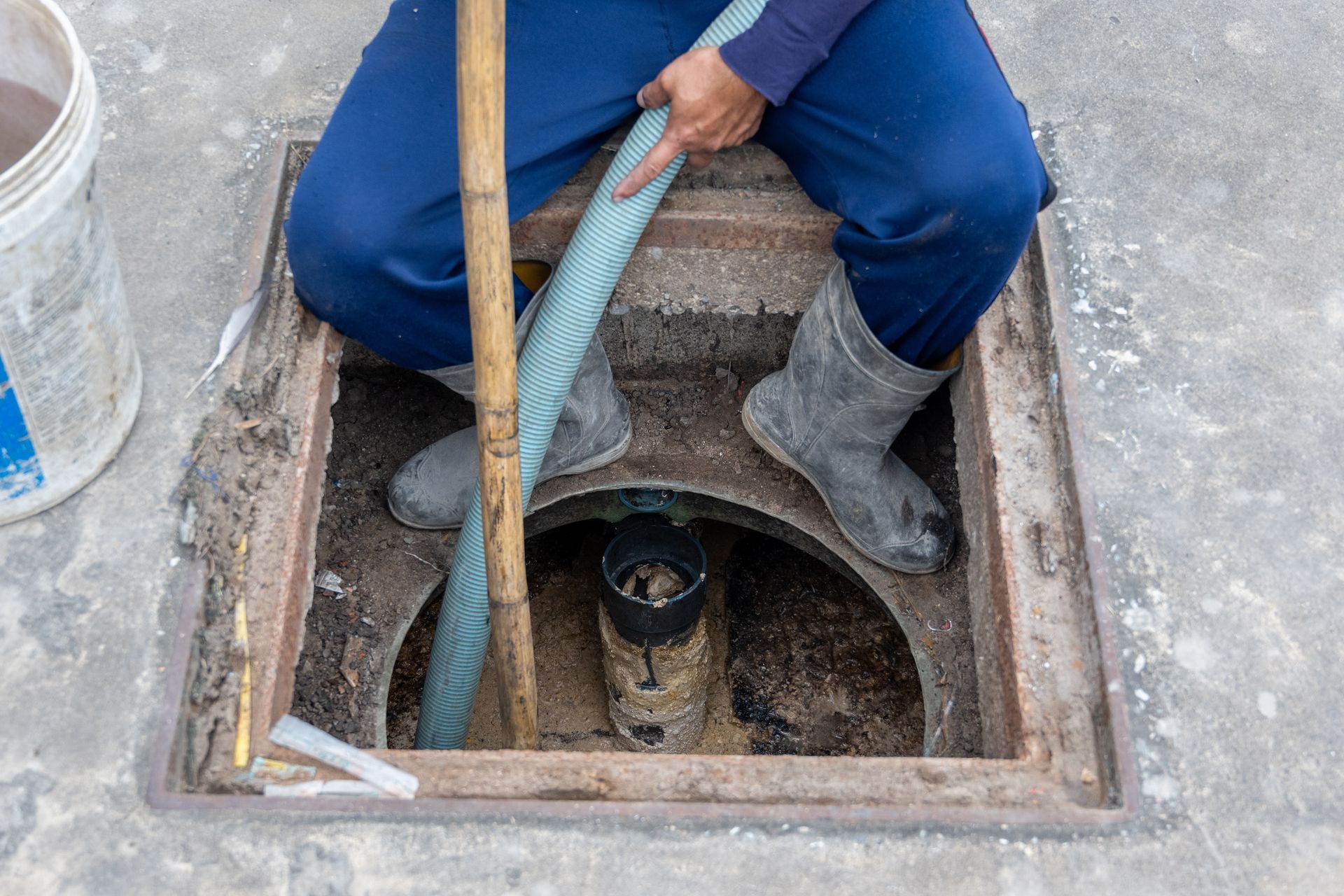 Septic System Service Company pumping a residential septic tank during routine maintenance.
