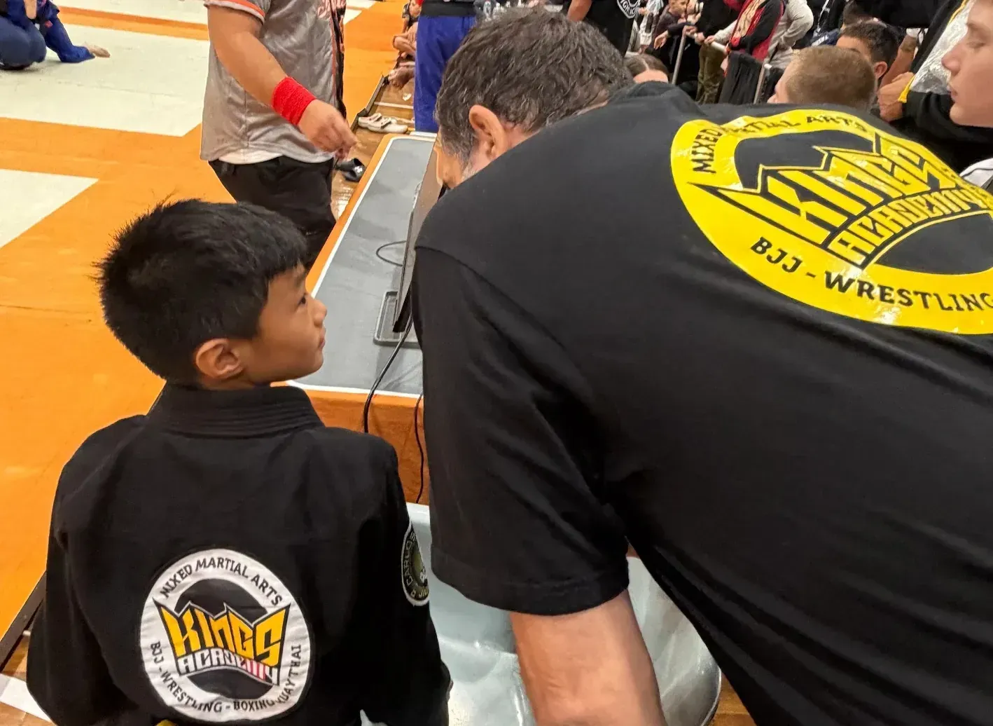 Elvis Sinosic coaching a student at the Grappling Industries BJJ event.