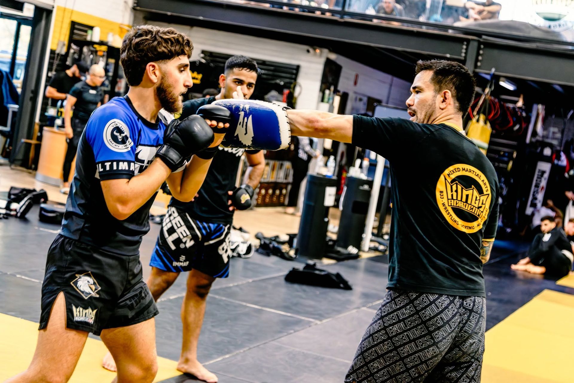 MMA Coach Jesh explaining a combination to students