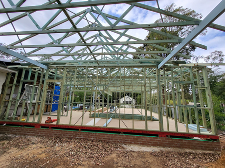 A house is being built with a lot of wooden beams.