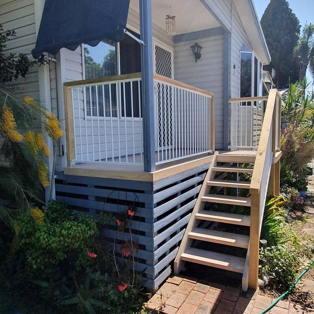 A house with a porch and stairs leading up to it.