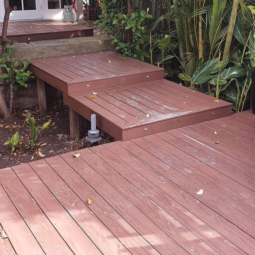 A wooden deck with steps leading up to it