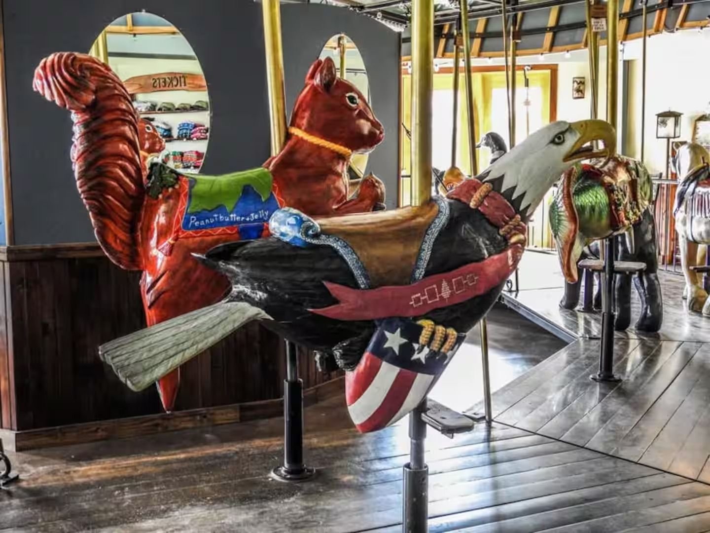 A carousel with a squirrel and an eagle on it