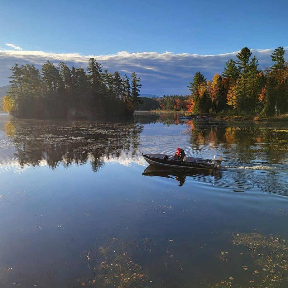 An aerial view of a boat floating on top of a body of water.