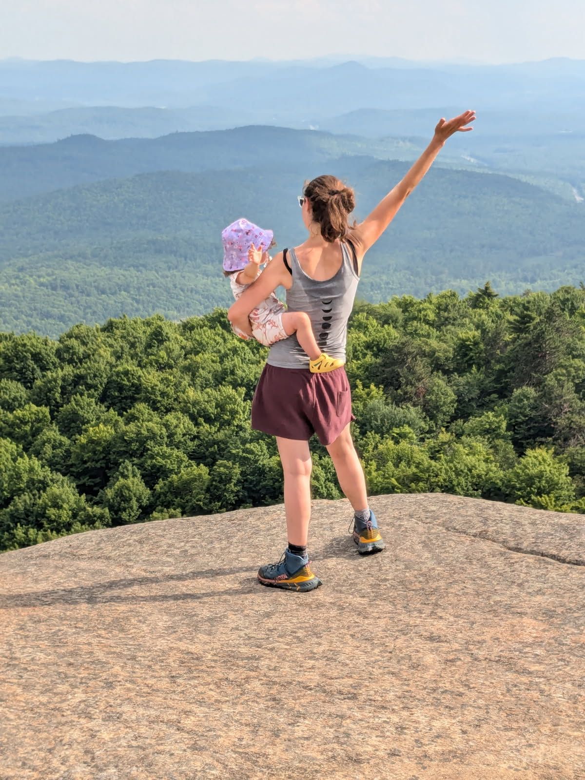 A group of people are walking down a path in the woods.