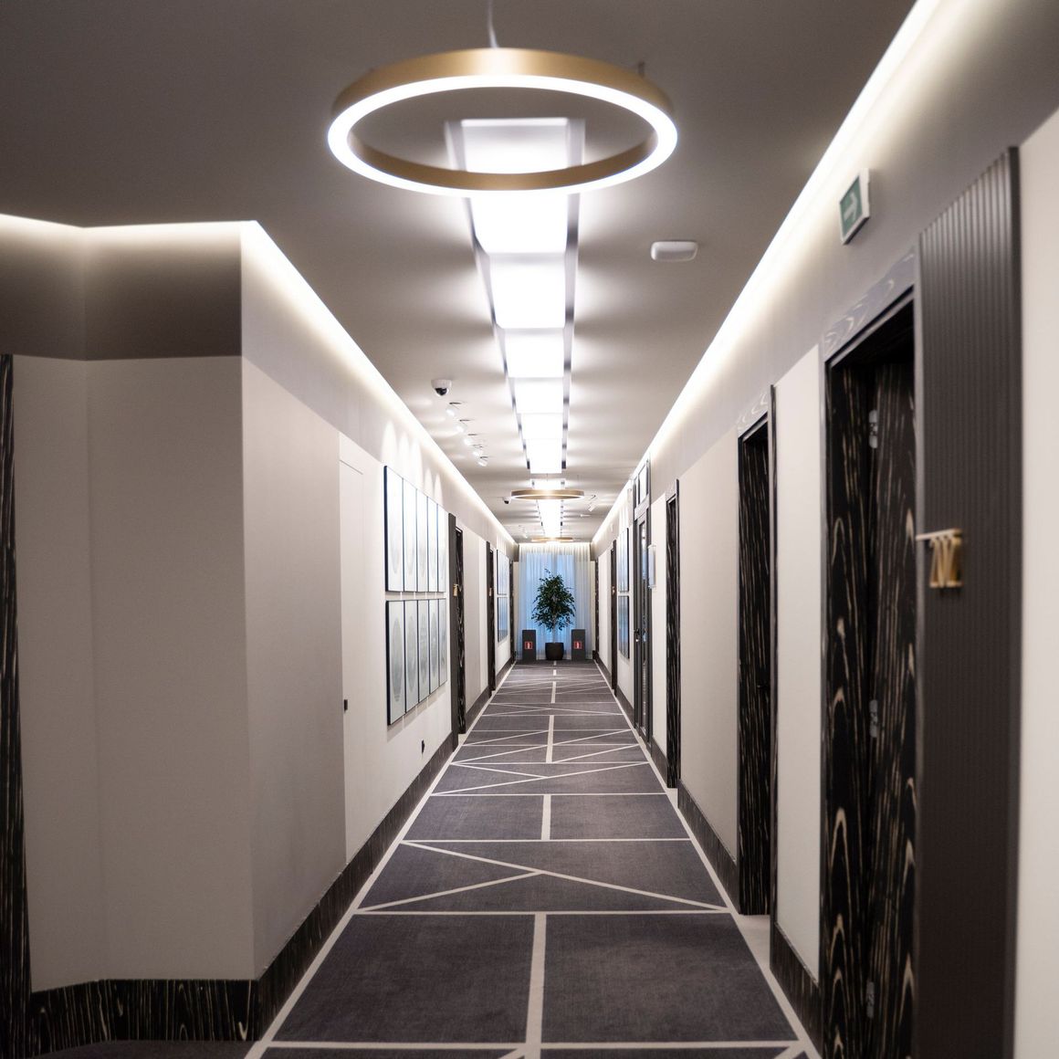 a long hallway with a circular light hanging from the ceiling