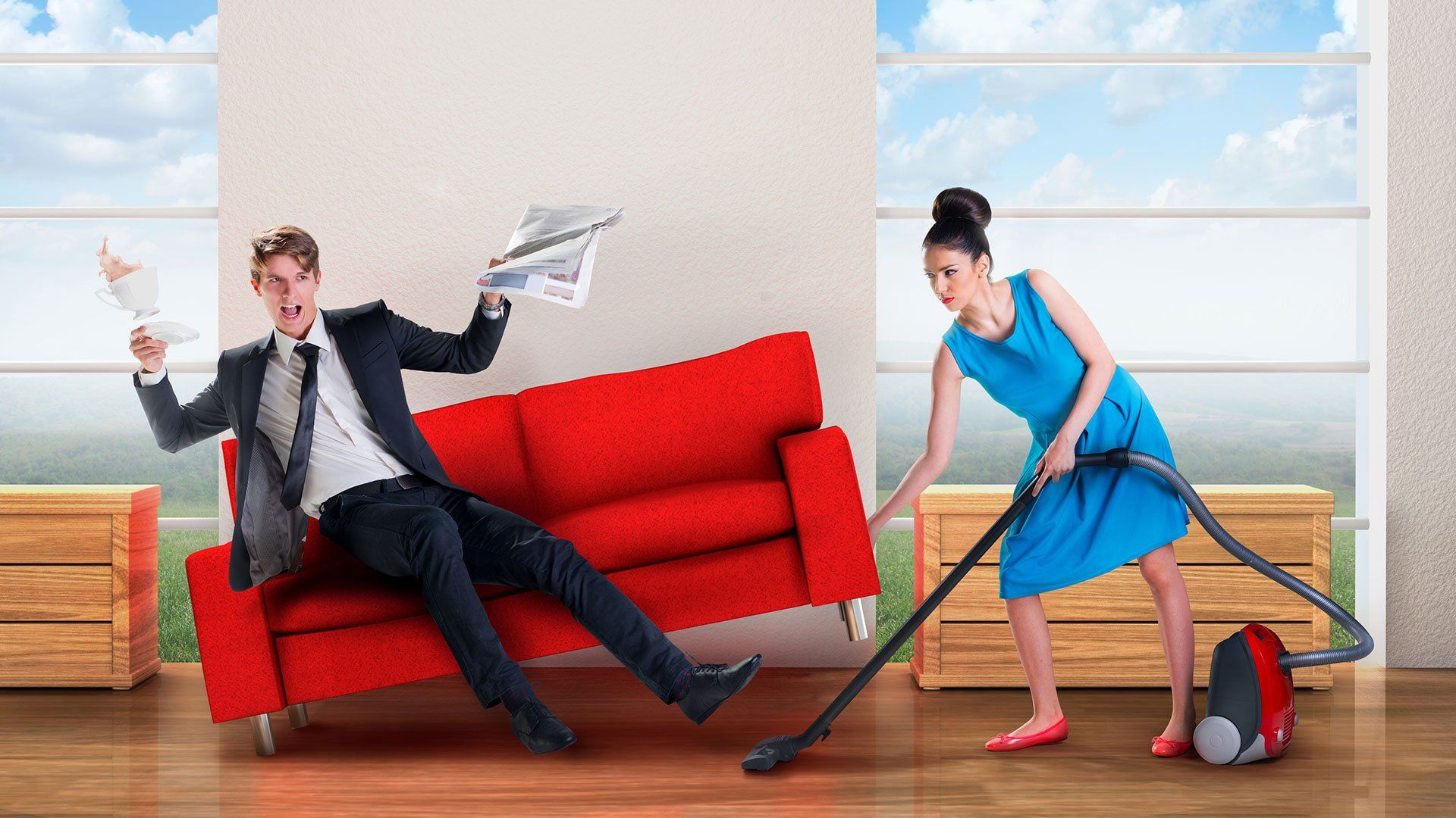 woman vaccuming under a couch