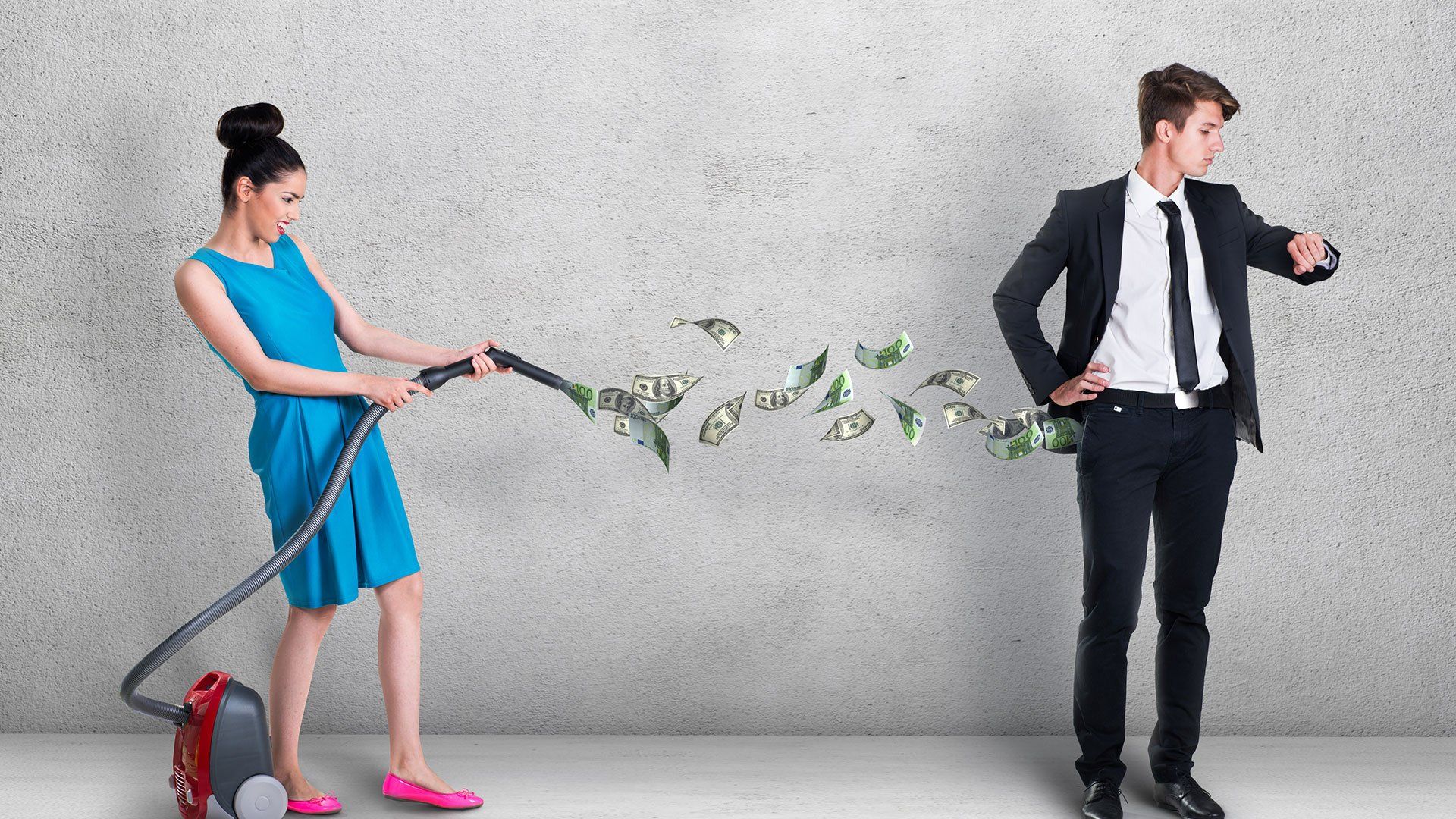 woman vacuuming money out of mans pockets