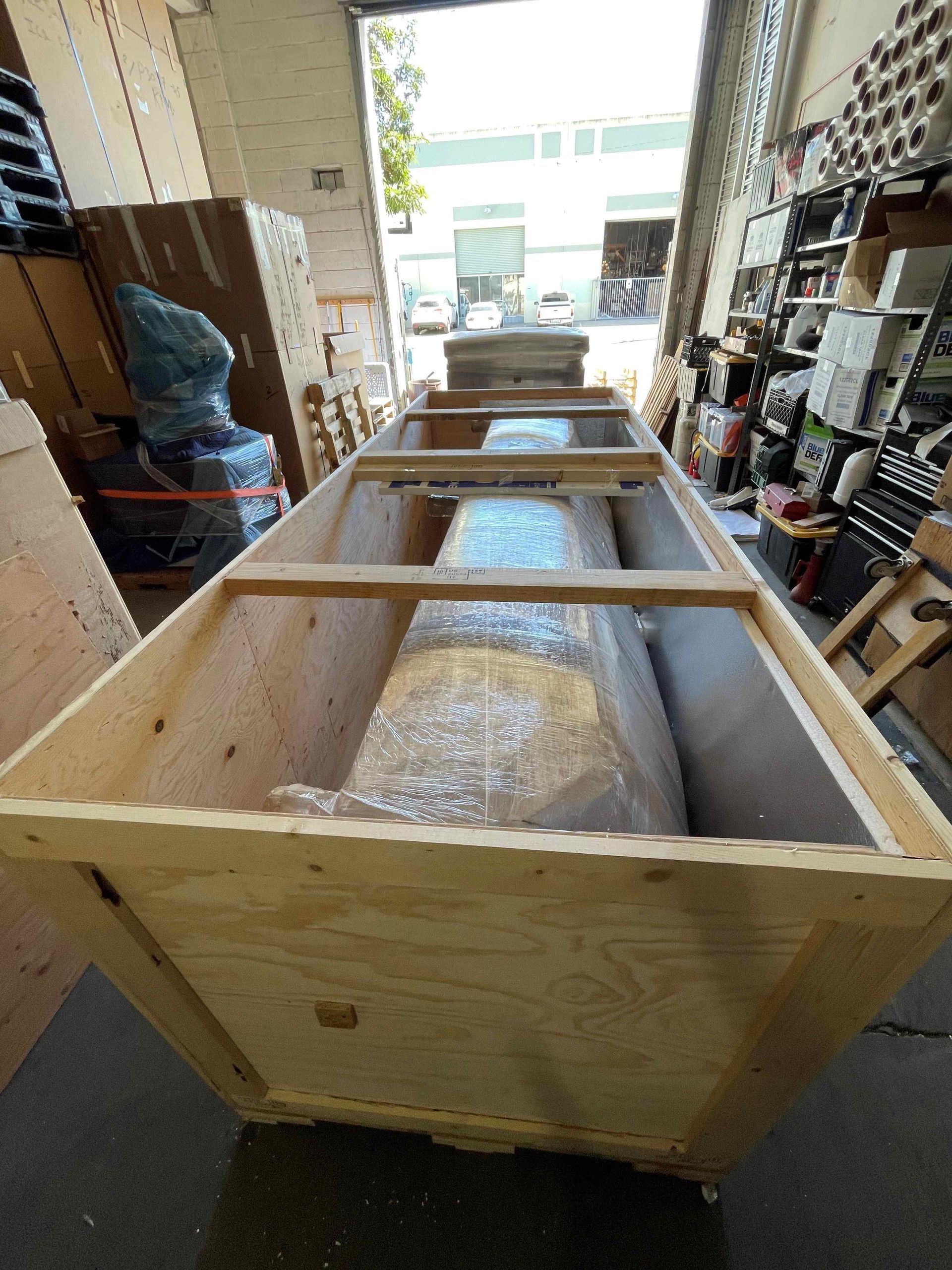 A large wooden box is sitting in a warehouse.